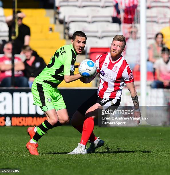 Lincoln City's Alan Power vies for possession with Forest Green Rovers' Liam Noble during the Vanarama National League match between Lincoln City and...