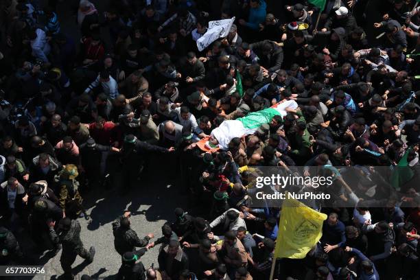 Members of the Ezzedine al-Qassam Brigades, the military wing of the Palestinian Islamist movement Hamas carry the body of Hamas official, Mazen...