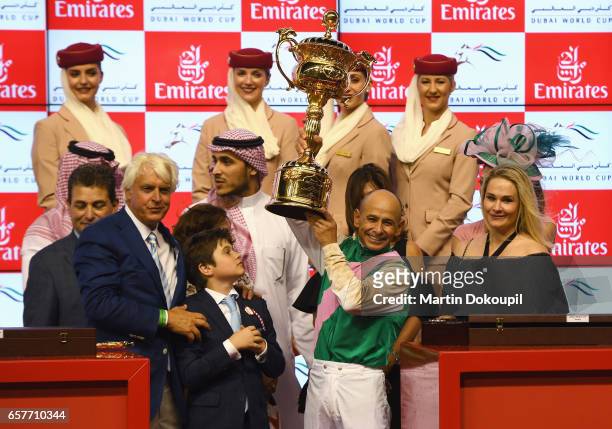 Jockey Mike Smith riding Arrogate celebrates with the trophy and trainer Bob Baffert after winning the Dubai World Cup Sponsored By Emirates Airline...