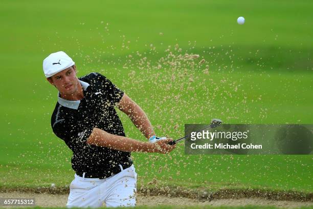Bryson DeChambeau plays his third shot out of the bunker on the fifth hole during the third round of the Puerto Rico Open at Coco Beach on March 25,...