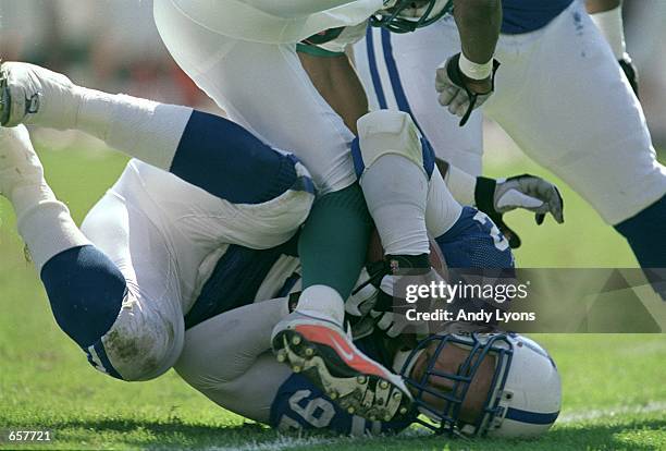 Chad Bratzke of the Indianapolis Colts gets tackled during the game against the Miami Dolphins at the Pro Players Stadium in Miami, Florida. The...