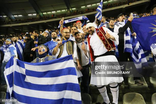 Greece's supporters wave national flags before the start of the FIFA World Cup 2018 qualifying football match between Belgium and Greece, at the King...