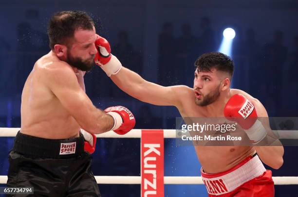 Artur Mann of Germany and Taras Oleksiyenko of Ukraine exchange punches during their cruiserweight fight at MBS Arena on March 25, 2017 in Potsdam,...