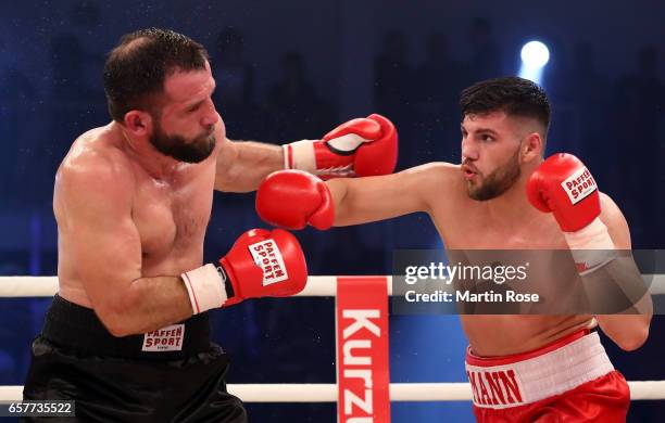 Artur Mann of Germany and Taras Oleksiyenko of Ukraine exchange punches during their cruiserweight fight at MBS Arena on March 25, 2017 in Potsdam,...