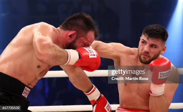 Artur Mann of Germany and Taras Oleksiyenko of Ukraine exchange punches during their cruiserweight fight at MBS Arena on March 25, 2017 in Potsdam,...