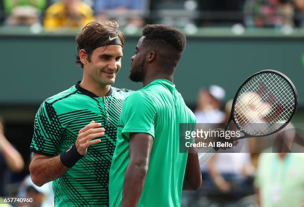 Roger Federer of Switzerland celebrates match point against Frances Tiafoe during day 6 of the Miami Open at Crandon Park Tennis Center on March 25,...