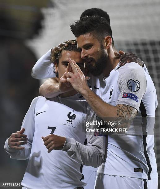 France's forward Antoine Griezmann is congratuled by teammates after scoring a goal during the FIFA World Cup 2018 qualifying football match between...