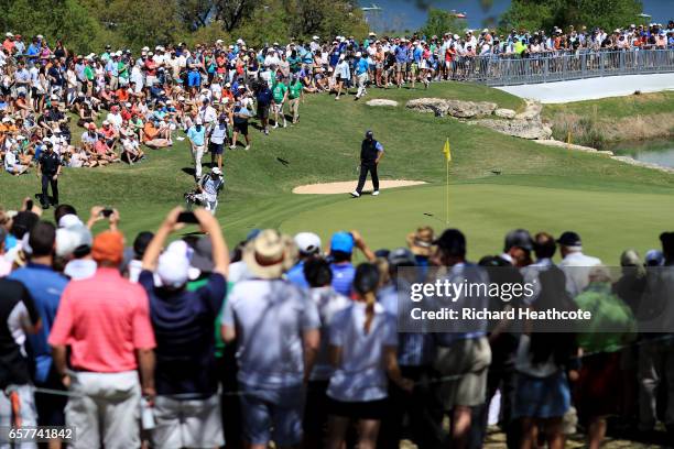 Phil Mickelson and Bill Haas walk on the 11th hole of their match during round five of the World Golf Championships-Dell Technologies Match Play at...