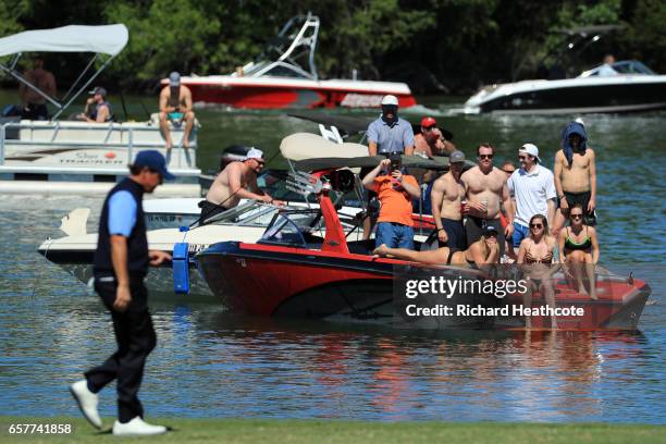 Fans watch as Phil Mickelson walks on the 14th hole of his match during round five of the World Golf Championships-Dell Technologies Match Play at...