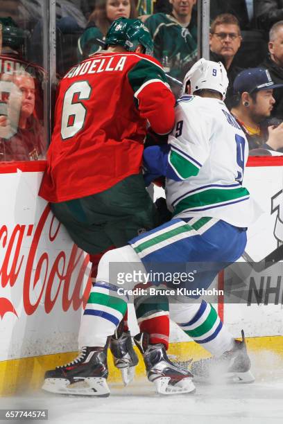 Jack Skille of the Vancouver Canucks battles with Marco Scandella of the Minnesota Wild along the boards during the game on March 25, 2017 at the...