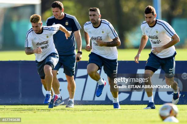 Argentina's defender Julio Buffarini , forward Lucas Pratto and forward Lucas Alario take part in a training session in Ezeiza, Buenos Aires on March...