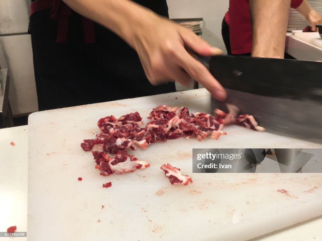 A Butcher Cutting Meat on Dirty Chopping Board, Food Pollution
