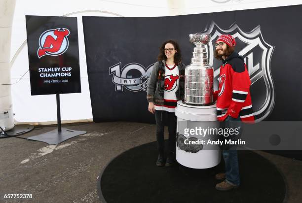 Fans pose for a photo with the Stanley Cup during the NHL Centennial Truck Tour at Prudential Center on March 25, 2017 in Newark, New Jersey.