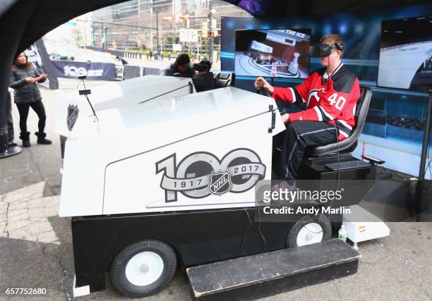 Fan rides a virtual reality ice cleaning machine during the NHL Centennial Truck Tour at Prudential Center on March 25, 2017 in Newark, New Jersey.