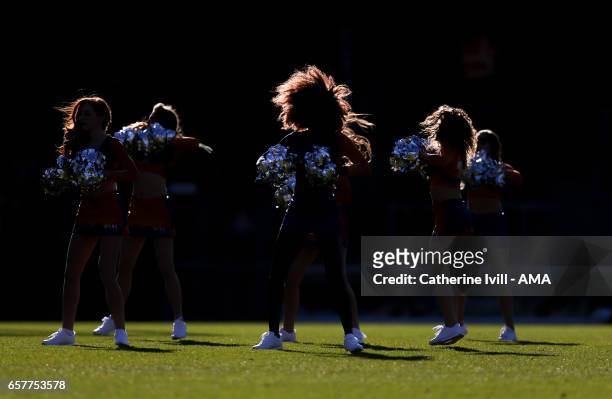 The sunshines on the hair of the Cheerleaders as they perform during the Sky Bet League Two match between Wycombe Wanderers and Notts County at Adams...