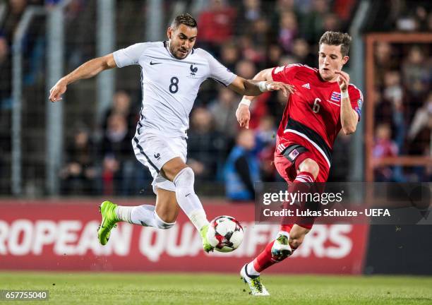 Dimitri Payet of France and Chris Philipps of Luxembourg in action during the FIFA 2018 World Cup Qualifier between Luxembourg and France at Stade...