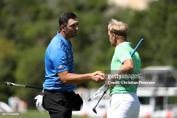 Jon Rahm of Spain shakes hands with Soren Kjeldsen of Denmark after winning their match 7&5 on the 13th hole during round five of the World Golf...