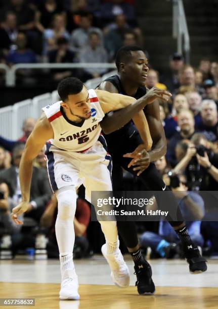 Nigel Williams-Goss of the Gonzaga Bulldogs and Malcolm Bernard of the Xavier Musketeers get tangled up in the first half during the 2017 NCAA Men's...