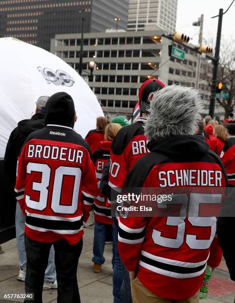 Fans wait in line to pose with the Stanley Cup as part of the NHL Centennial Truck tour open to fans before the game between the New Jersey Devils...