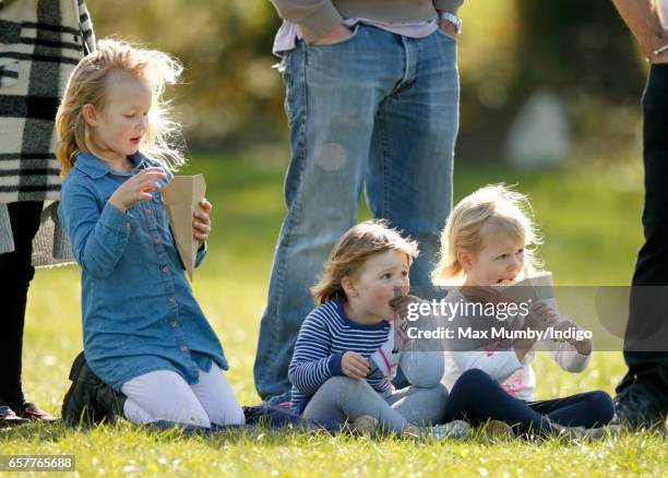 Savannah Phillips, Mia Tindall and Isla Phillips eat crepes as they attend the Gatcombe Horse Trials at Gatcombe Park on March 25, 2017 in Stroud,...