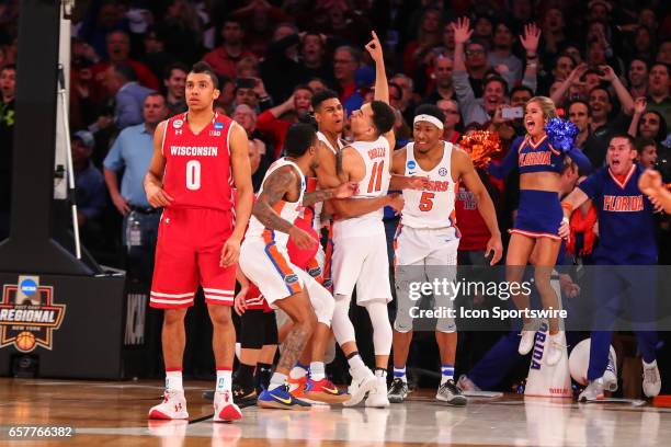 Florida Gators guard Chris Chiozza celebrates with teammates after making the game winning three point shot during overtime of the 2017 NCAA Men's...