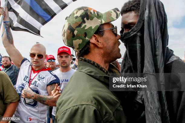 Scuffle breaks out between Pro-Trump and Anti-Trump protestors during Make America Great Again March on March 25, 2017 in Huntington Beach. According...