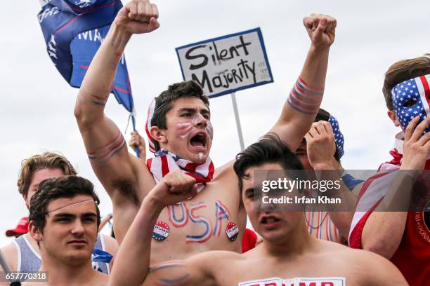 Scuffle breaks out between Pro-Trump and Anti-Trump protestors during Make America Great Again March on March 25, 2017 in Huntington Beach. According...