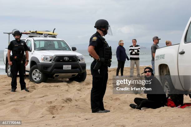 Scuffle breaks out between Pro-Trump and Anti-Trump protestors during Make America Great Again March on March 25, 2017 in Huntington Beach. According...