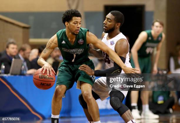 Justin Pitts of Northwest Missouri State University drives toward Shammgod Wells of Fairmont State University during the Division II Men's Basketball...