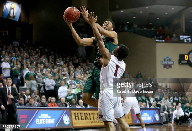 Anthony Woods of Northwest Missouri State University shoots past Jason Jolly of Fairmont State University during the Division II Men's Basketball...