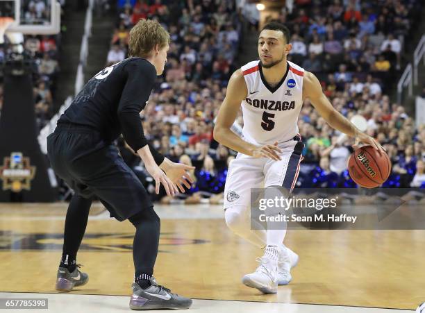 Nigel Williams-Goss of the Gonzaga Bulldogs is defended by J.P. Macura of the Xavier Musketeers during the 2017 NCAA Men's Basketball Tournament West...