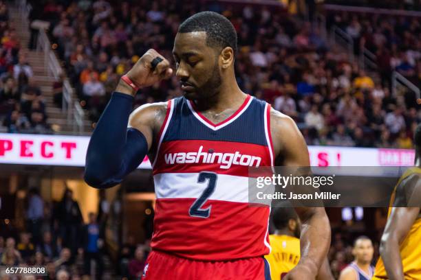 John Wall of the Washington Wizards celebrates after scoring during the first half against the Cleveland Cavaliers at Quicken Loans Arena on March...