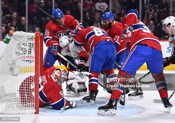 Carey Price,Jordie Benn and Nathan Beaulieu of the Montreal Canadiens defend the goal against Alexandre Burrows of the Ottawa Senators in the NHL...