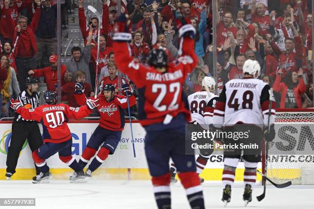 Daniel Winnik of the Washington Capitals celebrates with Marcus Johansson after scoring his first goal of the third period against the Arizona...