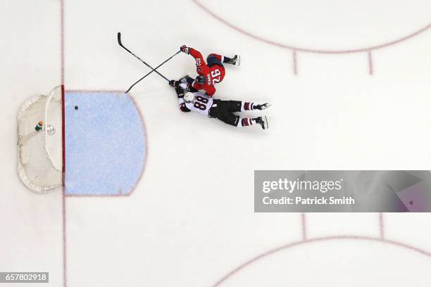 Daniel Winnik of the Washington Capitals scores an empty net goal in front of Jamie McGinn of the Arizona Coyotes during the third period at Verizon...