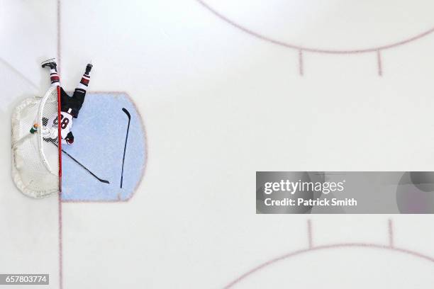 Jamie McGinn of the Arizona Coyotes lays on the ice after Daniel Winnik of the Washington Capitals , scored an empty net goal during the third period...