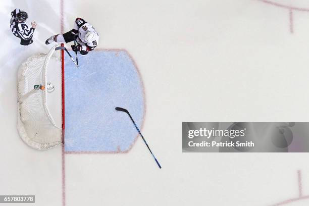 Jamie McGinn of the Arizona Coyotes breaks his stick over the crossbar after Daniel Winnik of the Washington Capitals , scored an empty net goal...