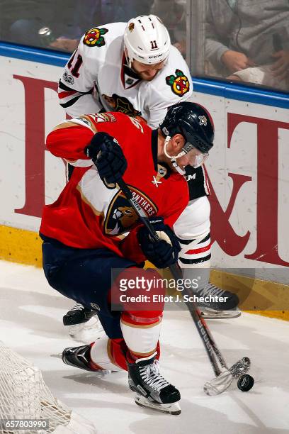 Aleksander Barkov of the Florida Panthers tangles with Andrew Desjardins of the Chicago Blackhawks at the BB&T Center on March 25, 2017 in Sunrise,...