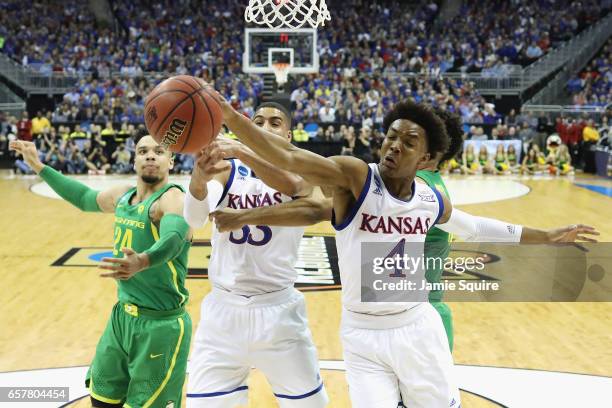 Devonte' Graham of the Kansas Jayhawks battles for a rebound in the first half against the Oregon Ducks during the 2017 NCAA Men's Basketball...