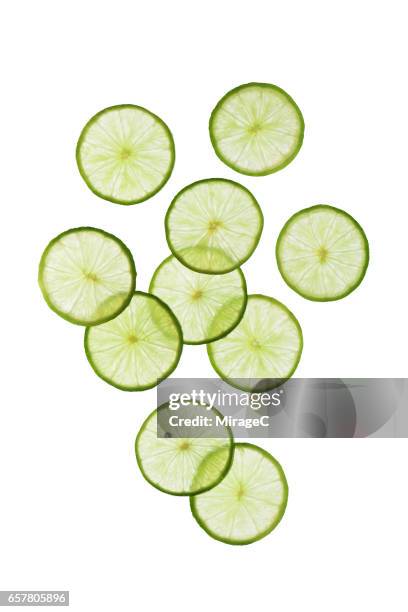 green lime slices on white background - lemon slices fotografías e imágenes de stock