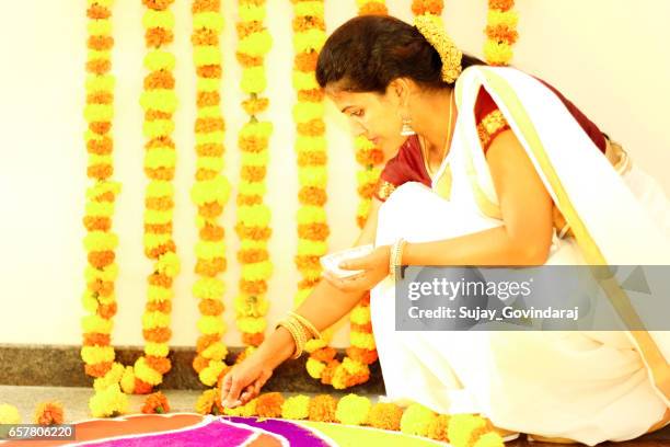 indian woman decorating the floor - onam stock pictures, royalty-free photos & images