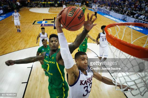 Jordan Bell of the Oregon Ducks defends a shot by Landen Lucas of the Kansas Jayhawks in the second half during the 2017 NCAA Men's Basketball...