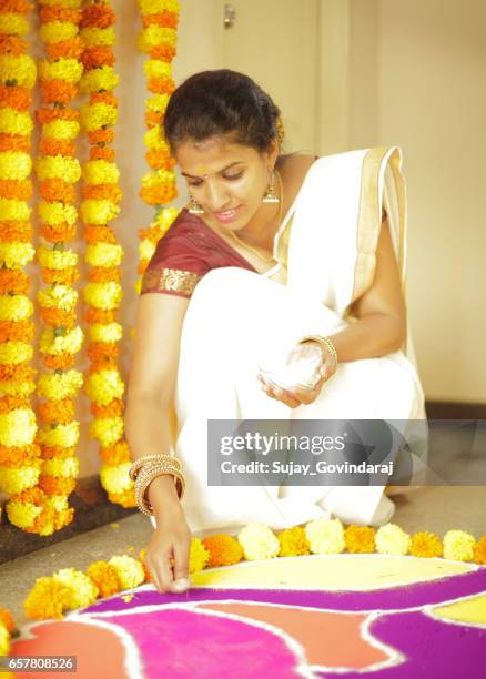 indian woman decorating the floor - onam stock pictures, royalty-free photos & images