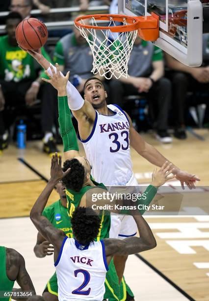 Kansas forward Landen Lucas reaches for rebound over Oregon forward Dillon Brooks in the first half in the NCAA Tournament's Midwest Region final at...