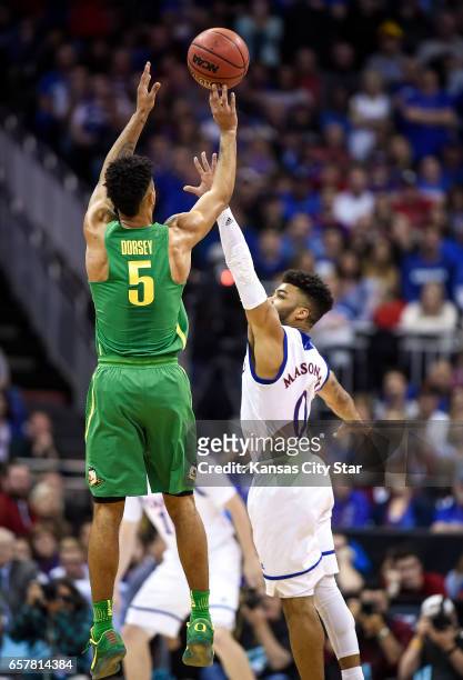 Oregon's Tyler Dorsey makes a 3-point shot over Kansas guard Frank Mason III in the first half during the NCAA Tournament's Midwest Region final at...