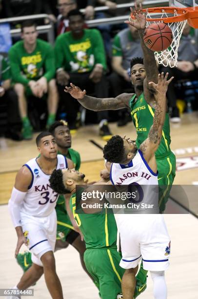 Oregon forward Jordan Bell blocks shot by Kansas guard Frank Mason III in the first half during the NCAA Tournament's Midwest Region final at the...
