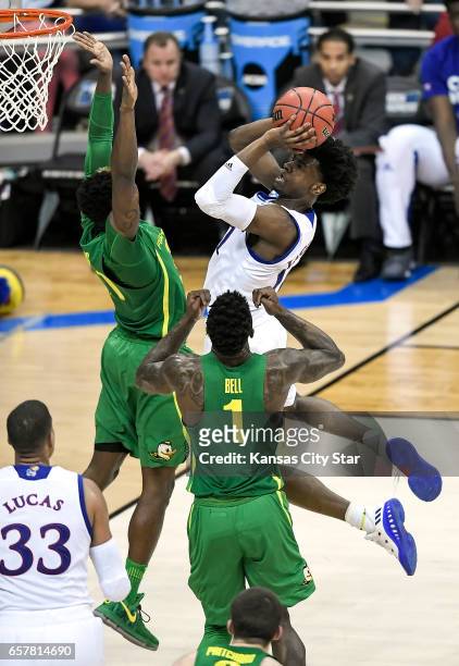 Kansas guard Josh Jackson drives to the basket against Oregon forward Jordan Bell in the second half during the NCAA Tournament's Midwest Region...