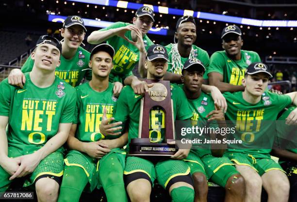 The Oregon Ducks pose after defeating the Kansas Jayhawks 74-60 during the 2017 NCAA Men's Basketball Tournament Midwest Regional at Sprint Center on...