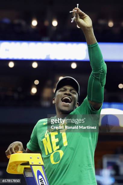 Dylan Ennis of the Oregon Ducks cuts the net after defeating the Kansas Jayhawks 74-60 during the 2017 NCAA Men's Basketball Tournament Midwest...