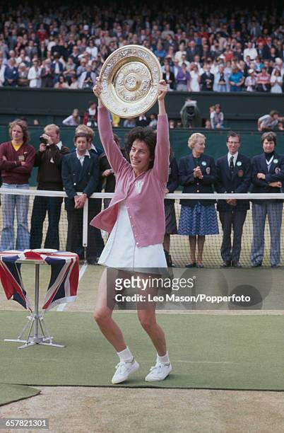 English tennis player Virginia Wade pictured raising the Venus Rosewater Dish trophy in the air after defeating Betty Stove to win the final of the...